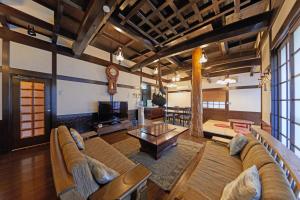 a living room with a couch and a table at Kyo-machiya Stay WAKA Fushimiinari in Kyoto