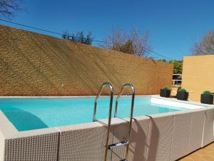 a swimming pool in front of a building with a fence at Villa Nice Mallorca in Palma de Mallorca