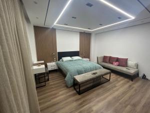 1 dormitorio con 1 cama y 1 sofá en شقة 200 متر جديدة بالكامل للايجار في الحى التاسع مدينة العبور القاهرة, en Obour