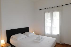 a bedroom with a white bed and a window at T2 "Les Hameaux du Soleil" with pool and parking in Villeneuve-Loubet