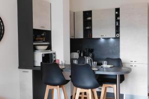 a kitchen with a table and four chairs at T2 "Les Hameaux du Soleil" with pool and parking in Villeneuve-Loubet