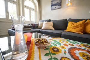 a living room with a table with a vase and a bowl of nuts at Villa Victoria - Nairs, Scuol in Scuol