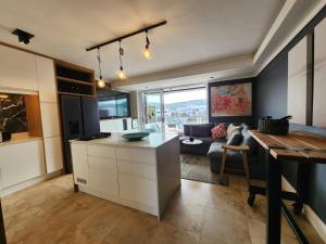 a kitchen and living room with a couch and a table at Quay Five on the Waterfront in Knysna +27 photos