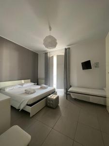 a bedroom with a large bed and a window at Via Itria in Marsala