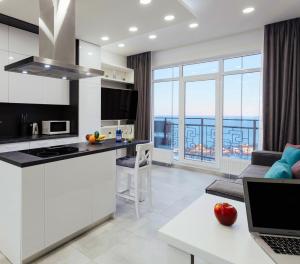 a kitchen and living room with a view at Sea Pearl in Odesa