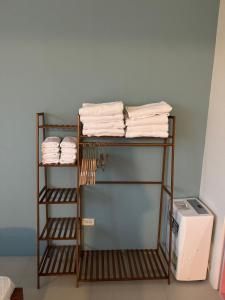 a towel rack with towels on it in a room at 旅居Villa in Dongshan