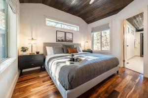 a bedroom with a large bed with a wooden floor at Cobalt Peak - Pet-Friendly Sauna Panoramic Views in Cascade-Chipita Park