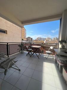 a balcony with a table and chairs on a building at Via Itria in Marsala