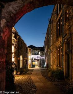an alley with an archway in an old building at Upside down in Settle. Stylish, central and cosy in Settle