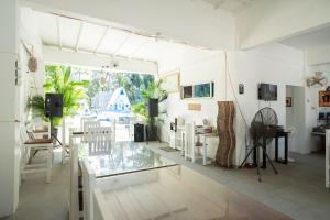 a living room with a glass table and chairs at Costas De Liwa Bar & Beach Resort in Zambales