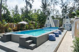 a swimming pool in a backyard at Costas De Liwa Bar & Beach Resort in Zambales