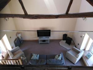 a living room with a couch and a flat screen tv at Upside down in Settle. Stylish, central and cosy in Settle