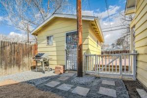 a small yellow house with a fence and a grill at Colorado Cottage - Downtown King Scenic in Colorado Springs