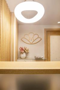 a room with a table with a large light fixture at Mariet Athens Boutique Spa in Athens