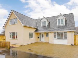 a white house with a gray roof at 4 Bed in Penygroes 86423 in Pen-y-groes