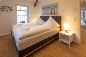 En eller flere senge i et værelse på Ferienwohnung Majorshof Seehecht Büsum
