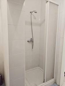 a shower with a glass door in a bathroom at Charming Senglea Studio in Senglea
