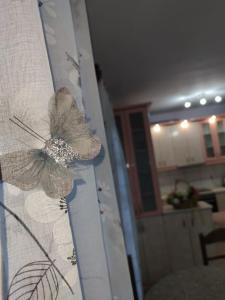 a curtain with a flower on a wall at Vrasna Luxury Apartment in Nea Vrasna