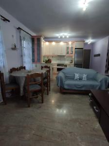 1 dormitorio con cama, mesa y cocina en Vrasna Luxury Apartment en Nea Vrasna
