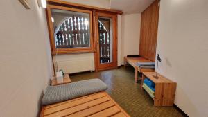 a hallway with benches and a window in a room at Chesa Bellaval, Haus la Vuolp 2-Zimmer-Dachwohung in Silvaplana +39 photos