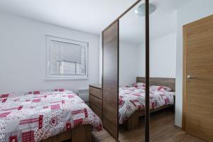 1 Schlafzimmer mit 2 Einzelbetten und einem Spiegel in der Unterkunft Cozy Apartment Bovec - Happy Rentals in Bovec