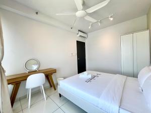 a white bedroom with a bed and a desk at Gaia Residence, Gamuda Gardens Rawang by Sleepy Bear in Kuala Lumpur