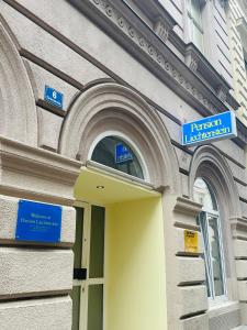 a building with blue signs on the side of it at Pension Liechtenstein in Vienna