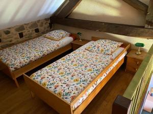two twin beds in a room with two tables at Domaine de Linars ☆ La Forge ☆ in Le Truel