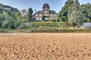 a large house on a hill with a dirt field at Domaine de Linars ☆ La Forge ☆ in Le Truel