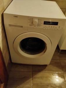 a white washing machine sitting in a bathroom at JIMMYS HOME in Skala Prinou