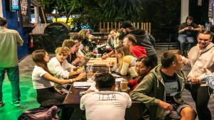 um grupo de pessoas sentadas em mesas em um restaurante em Mad Monkey Luang Prabang em Luang Prabang
