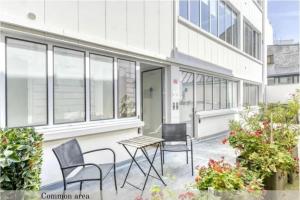 a patio with chairs and a table in front of a building at Montmartre Cozy and bright 1BD with terrace in Paris