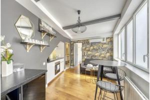 a kitchen and a living room with a table and chairs at Montmartre Cozy and bright 1BD with terrace in Paris