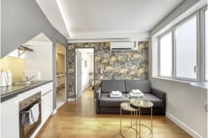 a living room with a couch and a table at Montmartre Cozy and bright 1BD with terrace in Paris