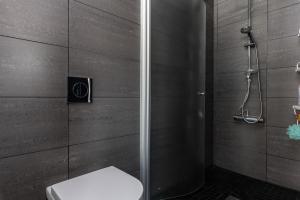 a bathroom with a shower with a toilet in it at Luleå Riverside Villa: Peace & Luxe in Gammelstaden
