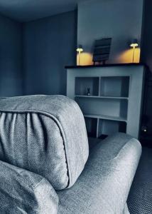 a living room with a couch and a table at Au coron des Anges ( Havré ) in Mons