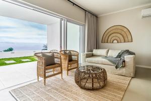 a living room with a couch and chairs at View16 in Cape Town