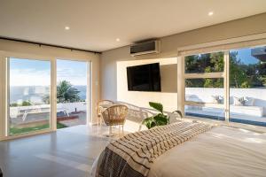 a bedroom with a bed and a view of the ocean at View16 in Cape Town