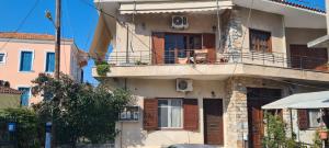 an apartment building with a balcony and a porch at CAPTAIN DALAS HOME in Mytilini