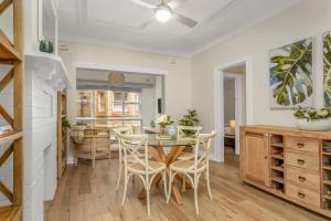 a kitchen and dining room with a table and chairs at Spacious 2-Bed Apartment in the heart of Manly in Sydney