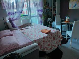 a bedroom with a bed and a table and a window at Focolare domestico in Milan