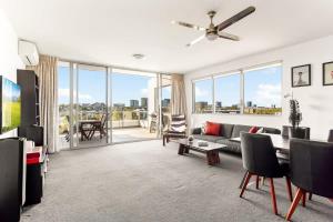 a living room with a couch and a table at Spacious 2-Bed with Two Balconies with City Views in Sydney