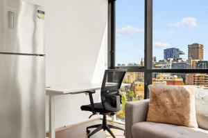 an office with a desk and a chair in front of a window at Modern 1-Bed in CBD with Views near Chinatown in Sydney