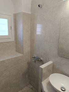 a bathroom with a shower and a sink at Marcos Rooms in Oia