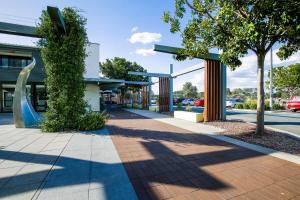 a sidewalk in front of a gas station at Gorgeous 2-Bed Apartment By Shops and the River in Batemans Bay