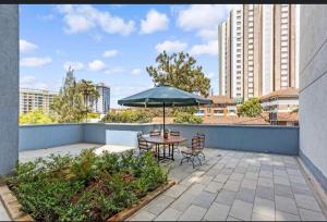 a patio with a table and chairs and an umbrella at pk Luxury Homes in Nairobi
