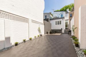 a courtyard in a home with a white wall at Superb 3-Bed Victorian Terrace by Darling Harbour in Sydney