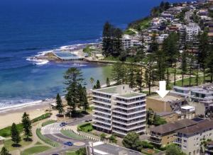 an aerial view of a beach and a building at Glorious Beachfront 3-Bed with Breathtaking Views in Deewhy