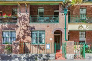 a red brick building with windows and a door at Quaint 3-Bed Heritage Home in the Heart of Sydney in Sydney