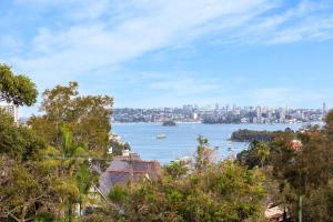 a view of a large body of water with a city at Huge Harbour View Apartment In Historic Home in Sydney